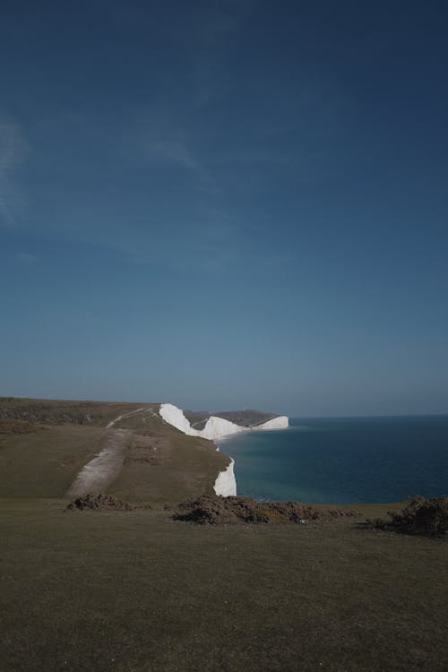 Adult walking confidently on a coastal path as part of cardiac rehabilitation