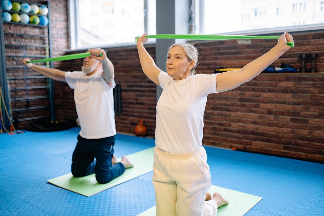 Adult performing a supported exercise during recovery from hip replacement surgery