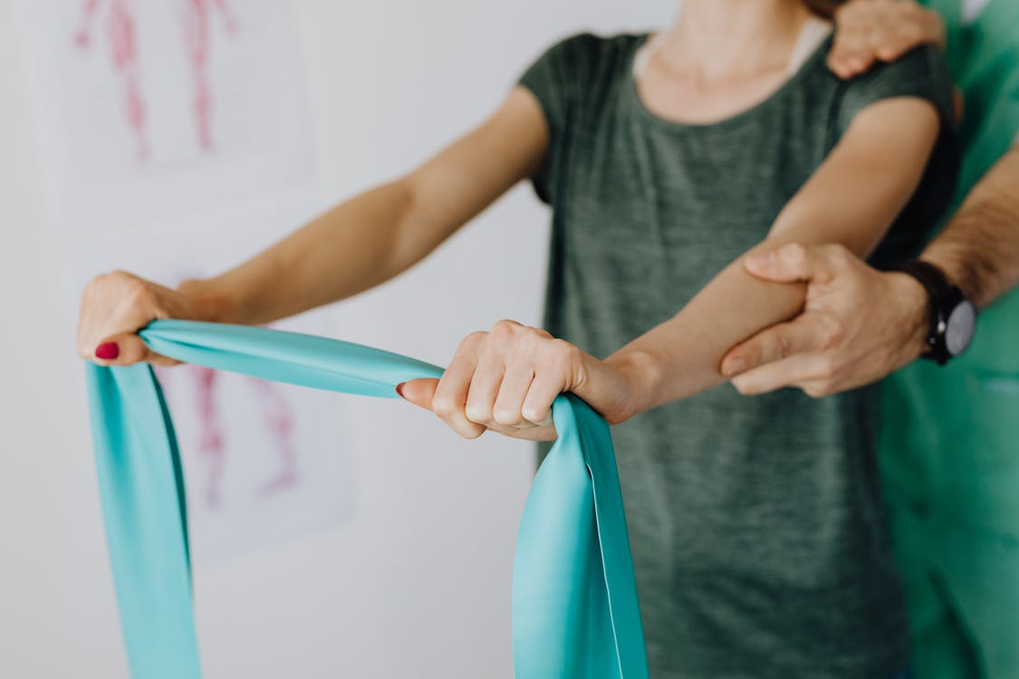 Adult performing a resistance band exercise at home
